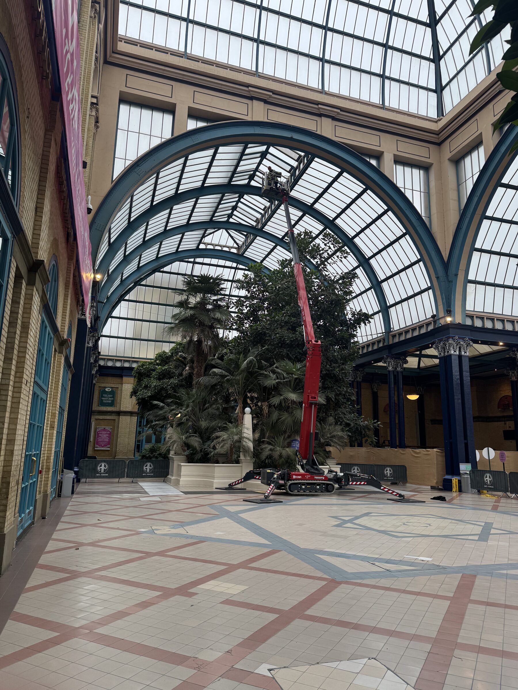 Palm Court at Alexandra Palace: barrel-vaulted Georgian wired glass ceiling with red spider lift and AP barriers — 89 Georgian wired glass replacements